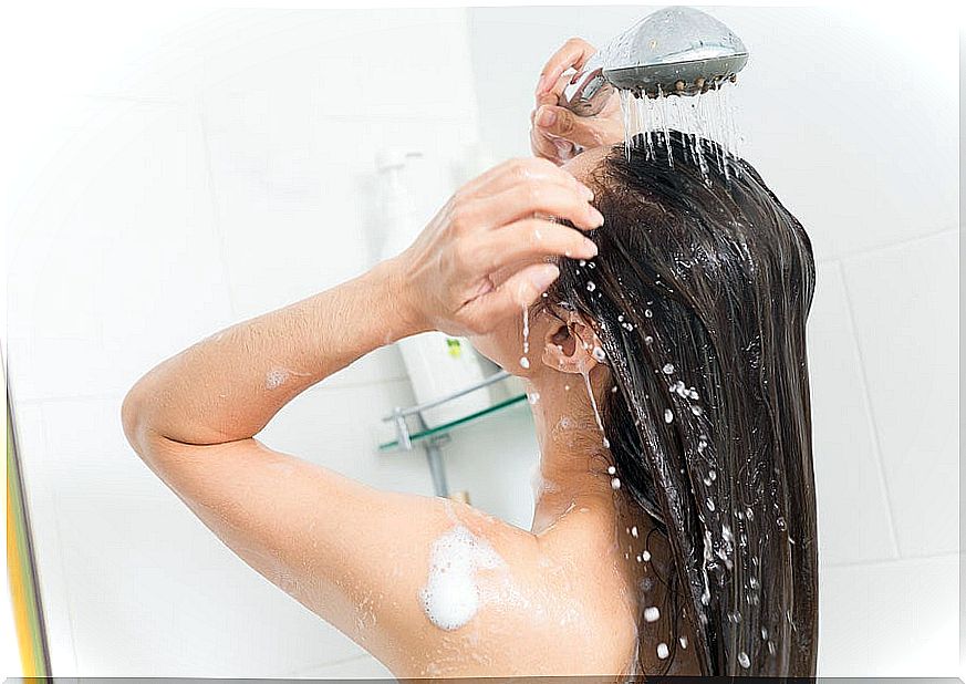 Woman taking shower with hot water