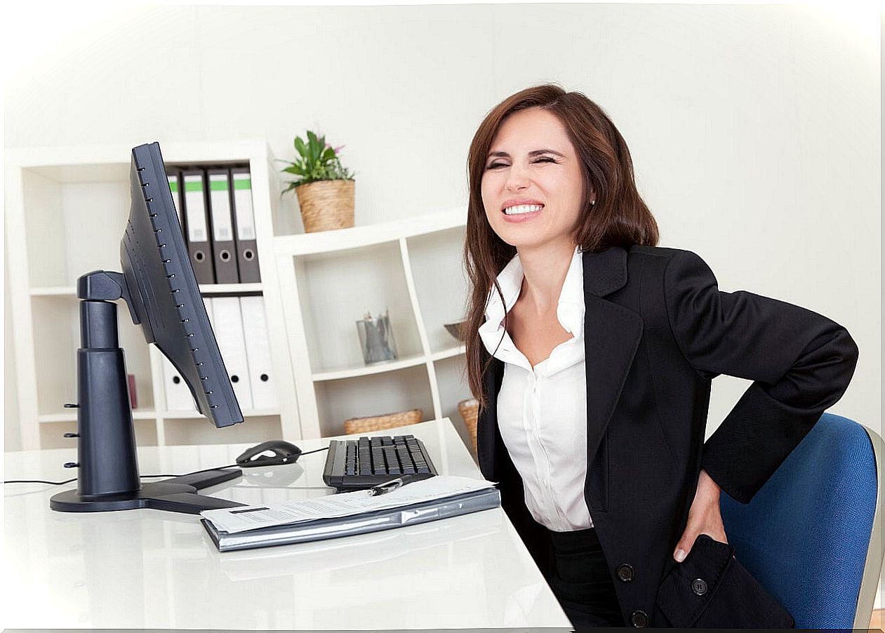 Woman with back pain from sitting at the computer