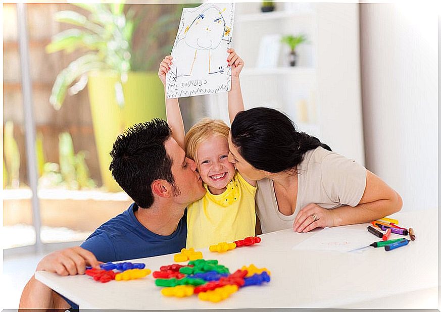 Parents kissing their daughter