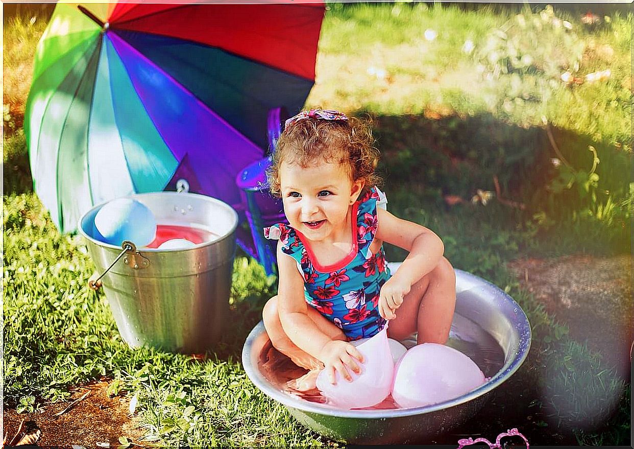 Girl playing with water balloons