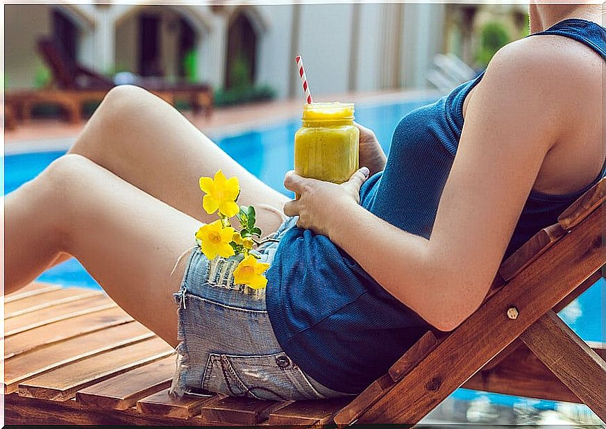 Having a smoothie in front of the pool