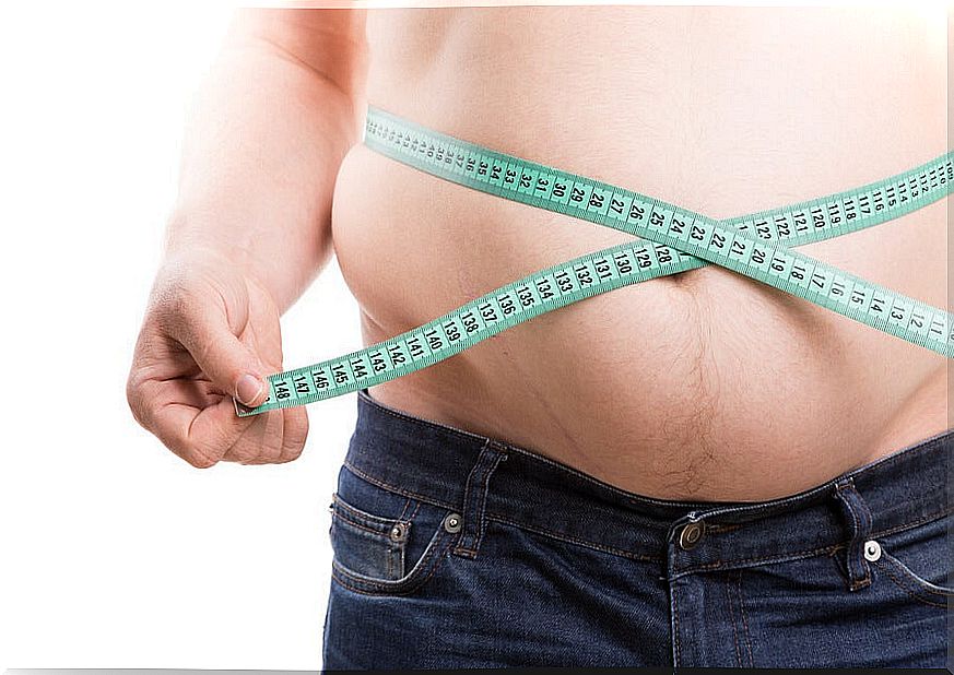 Man with obesity and a measuring tape on the abdomen