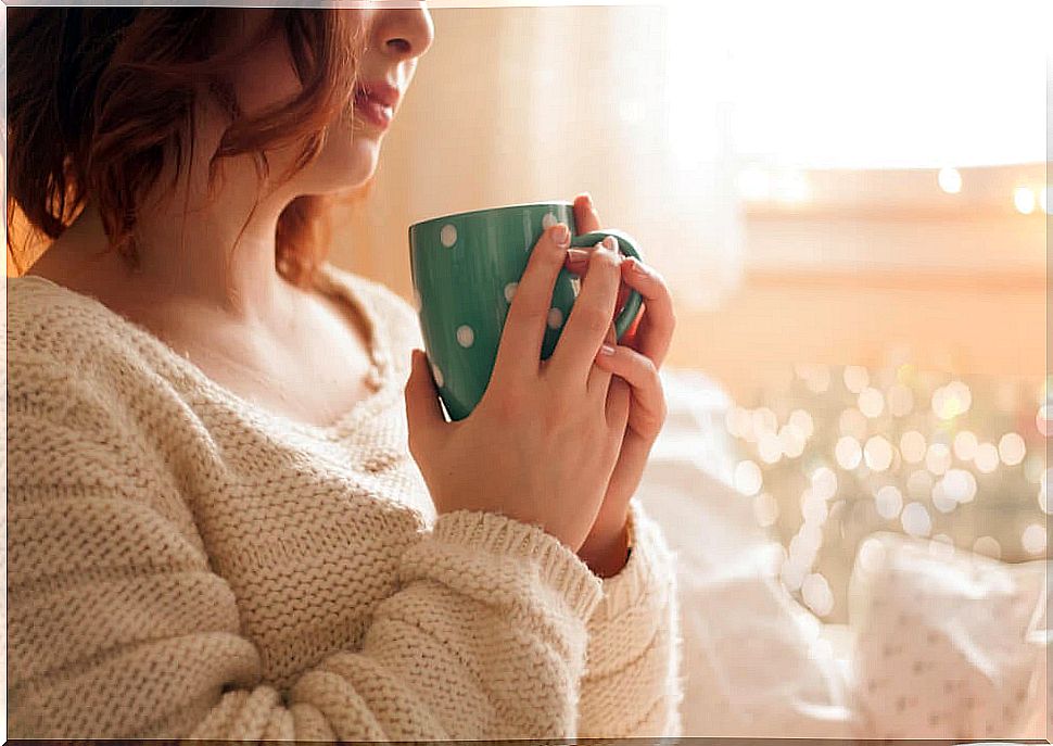 Woman with hot drink to avoid hypothermia