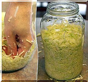 Pot with sauerkraut squeezing the mixture