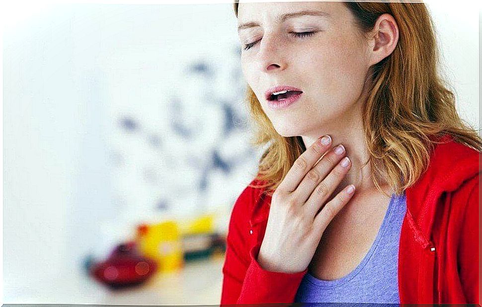 Woman touching her throat.