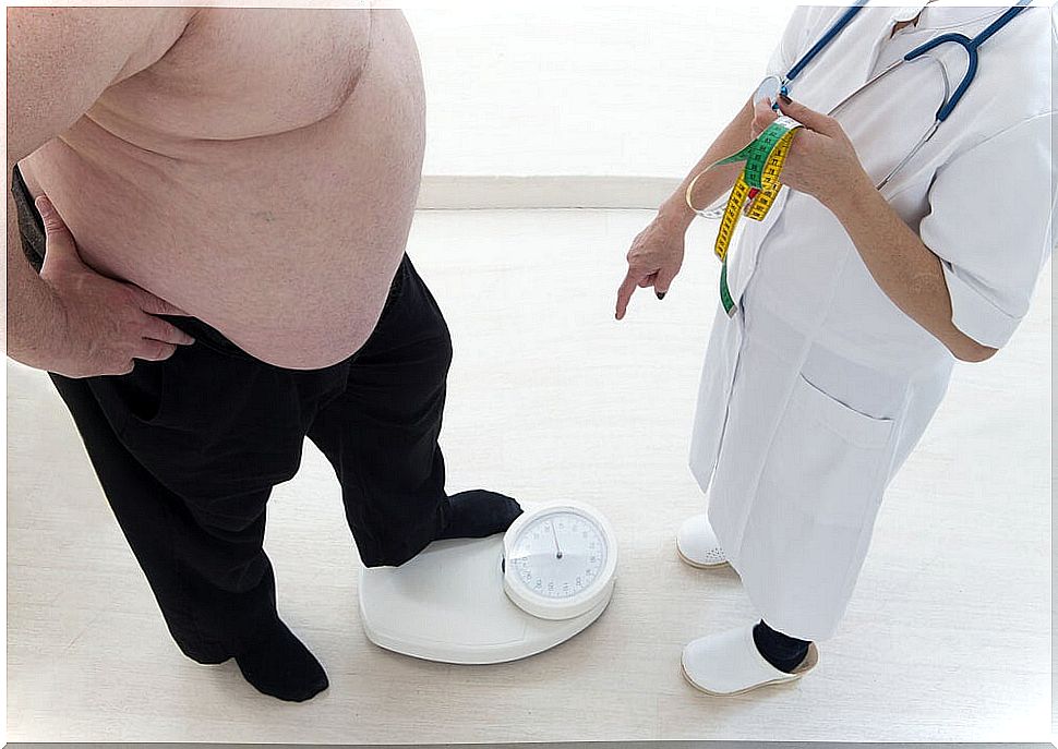 Obese man weighing himself.